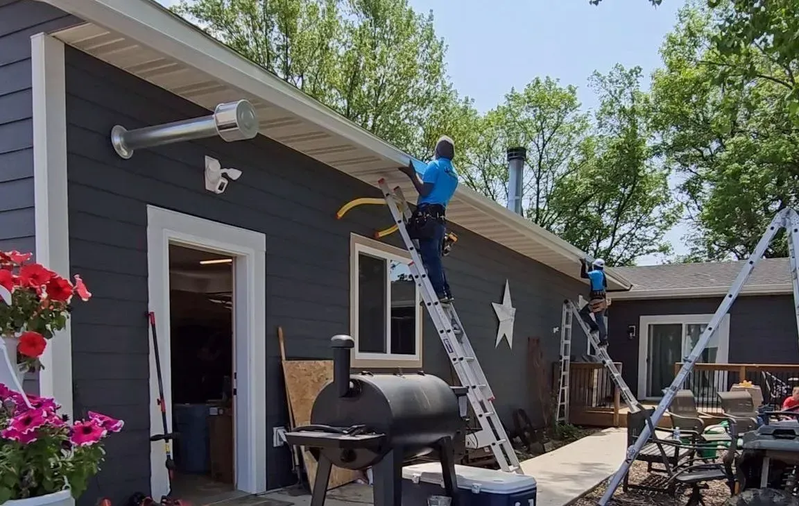 Professionals installing a seamless gutter in New Prague, MN